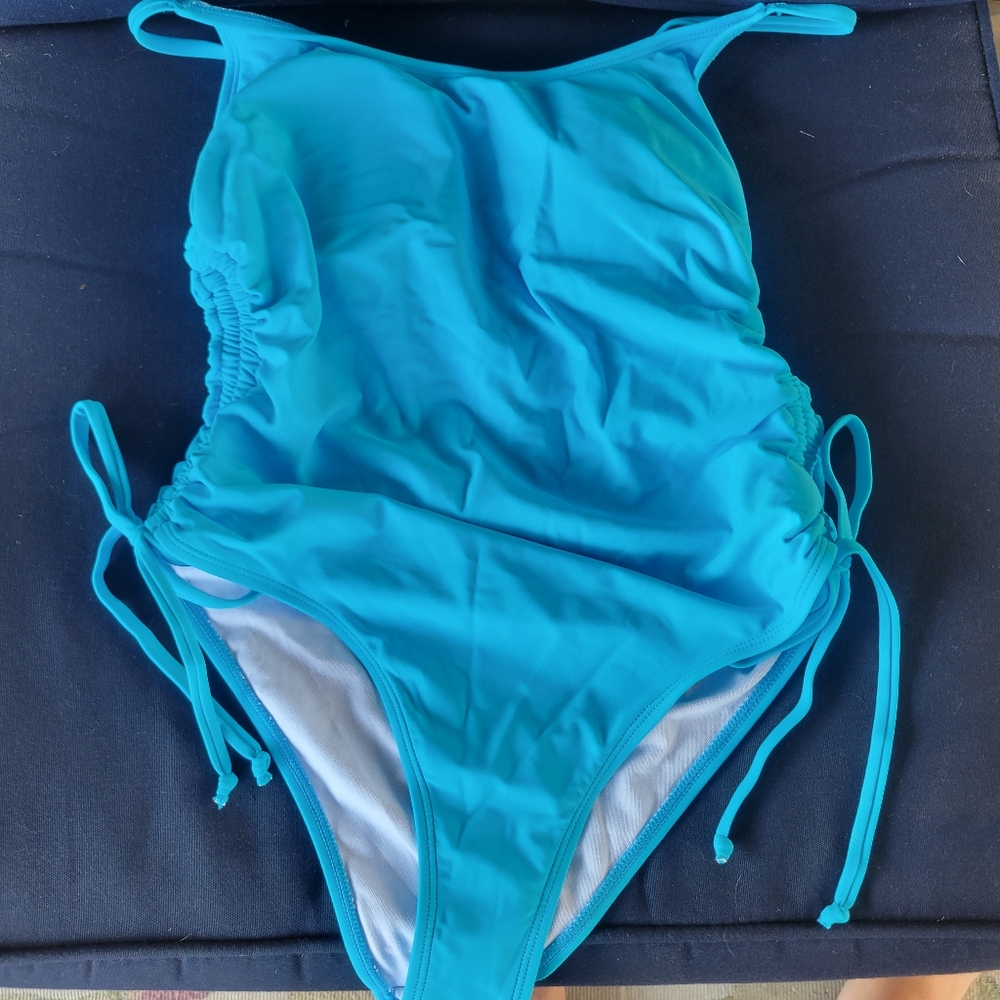 Blue one piece bathing suit with adjustable Thigh coverage. Large
